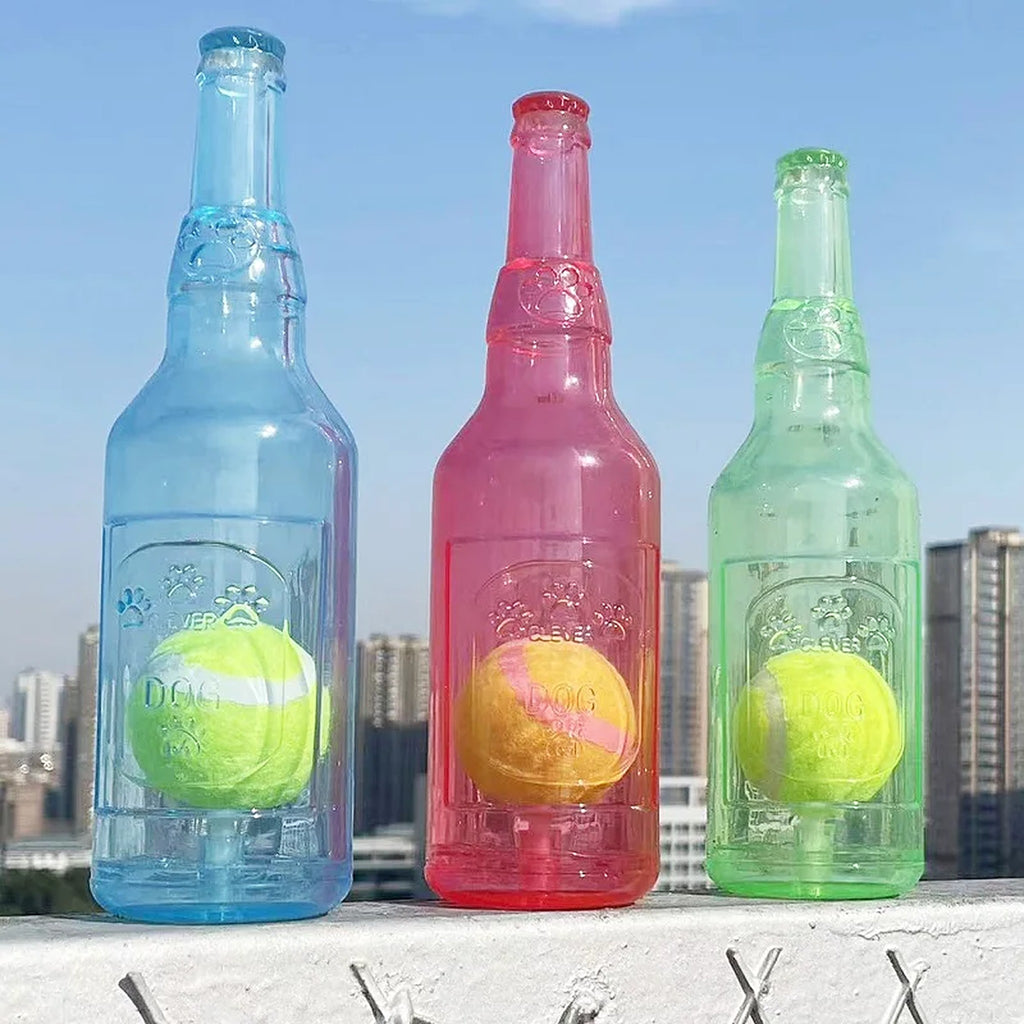 Clear blue, red and green squeaky bottle dog toys, each holding a tennis ball