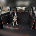 Border collie sitting on the black Waterproof Car Seat Hammock with orange edging across the back seat of a car
