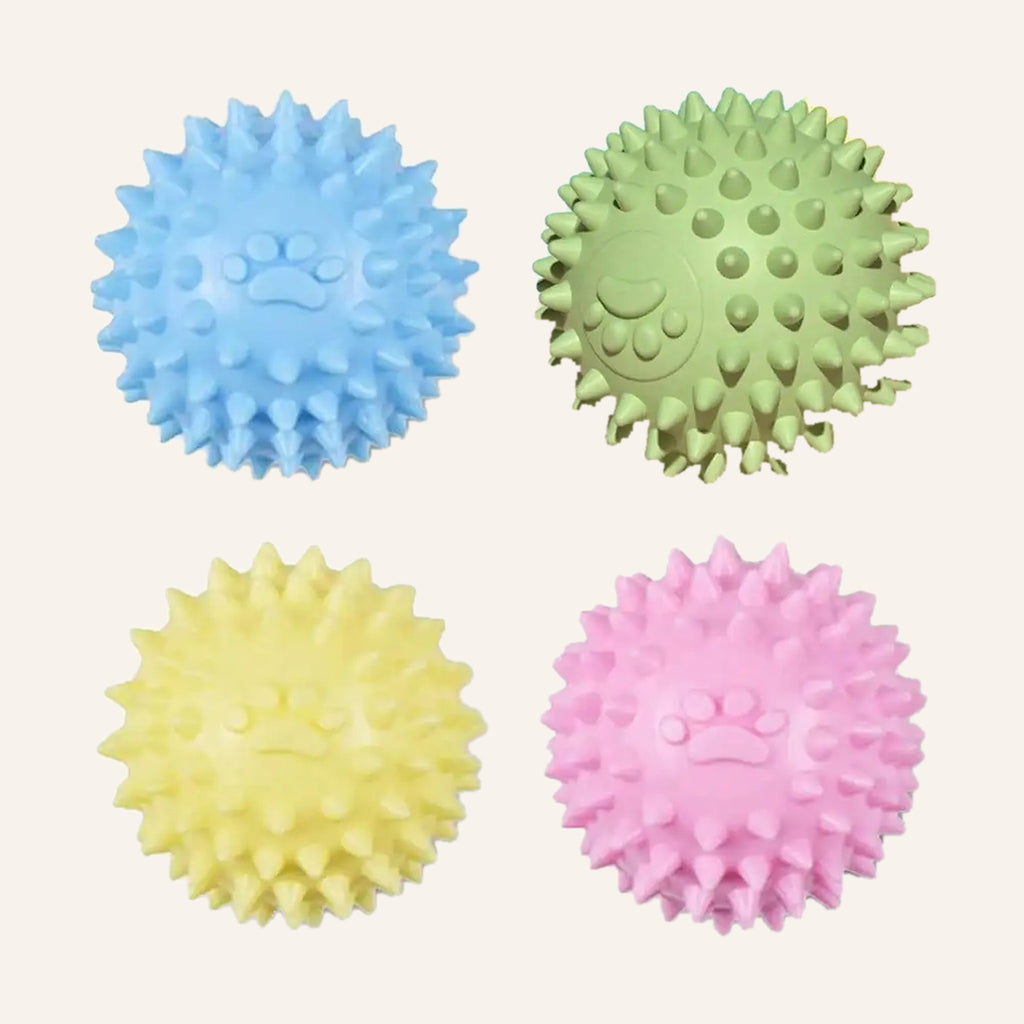Spiky rubber dog balls in blue, green, yellow and pink with a moulded paw print